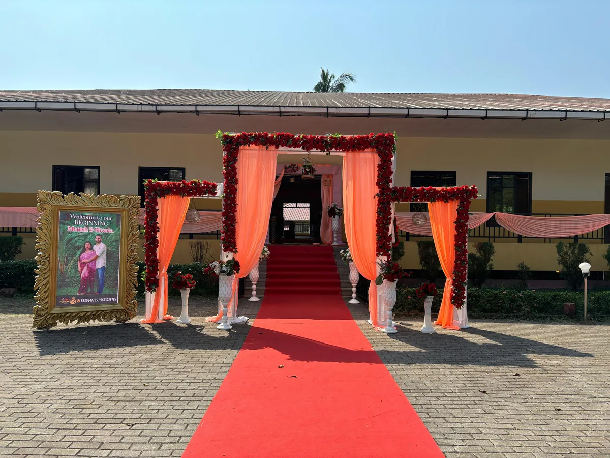 Red carpet entrance with floral drapes at Yeshwant Hall