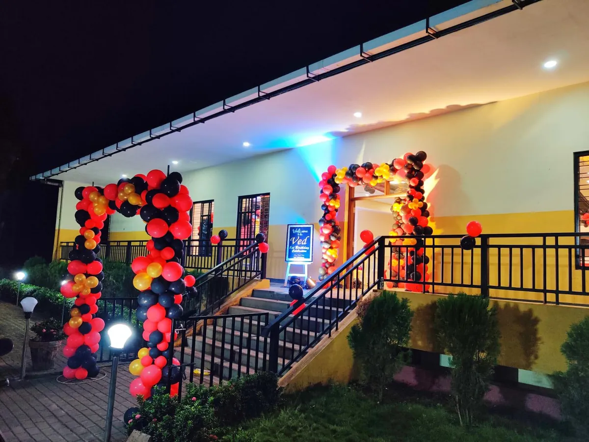 Balloon arch entrance lit up at night for a first birthday at Yeshwant Hall