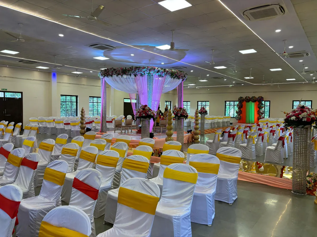 Wedding seating arranged around a floral mandap at Yeshwant Hall
